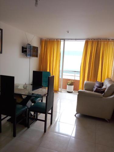 a living room with a table and a chair and a couch at HOSPEDAJE-FLORIDABLANCA-SANTANDER in Floridablanca