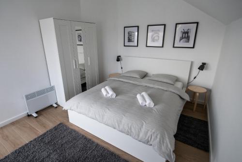 a bedroom with a white bed with two white pillows at Paula&Matej Airport Zagreb in Selnica Šćitarjevska