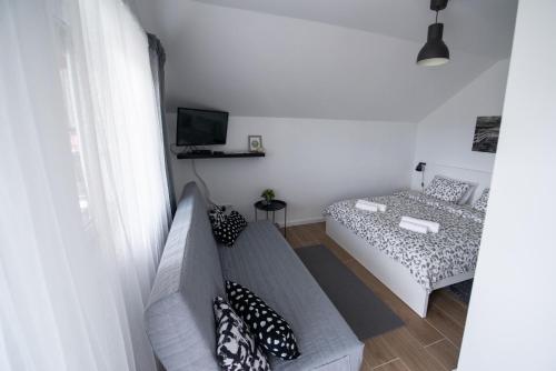 a living room with a couch and a bed at Paula&Matej Airport Zagreb in Selnica Šćitarjevska