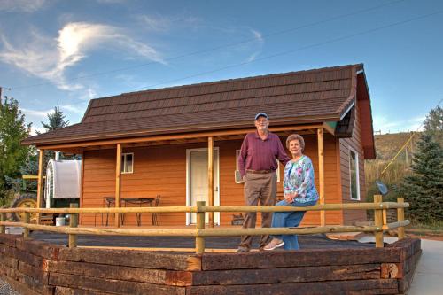 a man and woman standing in front of a tiny house at K3 Guest Ranch in Cody