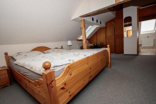 KoldenbüttelにあるFreesenkoogの部屋に木製のベッドがある寝室
