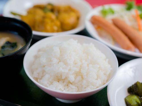 a table topped with bowls of rice and other foods at SUPER HOTEL Tokyo Akabane Station Higashiguchi Ichibangai in Tokyo