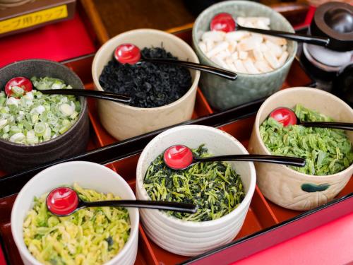 a group of bowls of food with cherries on top at SUPER HOTEL Tokyo Akabane Station Higashiguchi Ichibangai in Tokyo