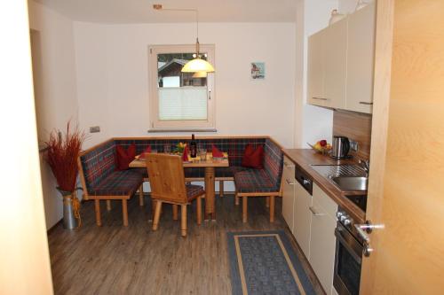 a kitchen with a table and chairs in a kitchen at Haus Markus in Fügen