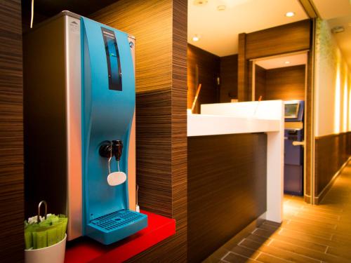 a bathroom with a laptop on a counter with a sink at SUPER HOTEL Tokyo Akabane Station Higashiguchi Ichibangai in Tokyo