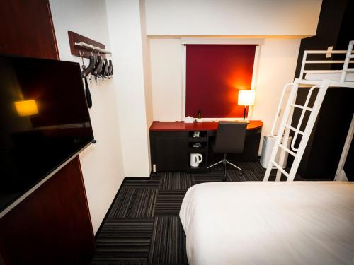a hotel room with a bed and a desk and a ladder at SUPER HOTEL Tokyo Akabane Station Higashiguchi Ichibangai in Tokyo