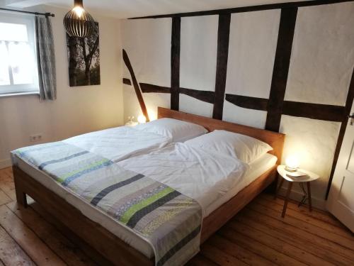 a bedroom with a large bed with a wooden headboard at Ferienhaus Sosberg in Sosberg
