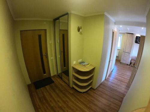 a room with a mirror and a wooden floor at Lavander suite in Ventspils
