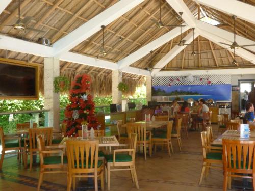 a restaurant with tables and chairs and a christmas tree at Costa Azul Suites 905 in Santa Marta