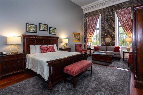 a bedroom with a bed and a living room at East Bay Inn, Historic Inns of Savannah Collection in Savannah