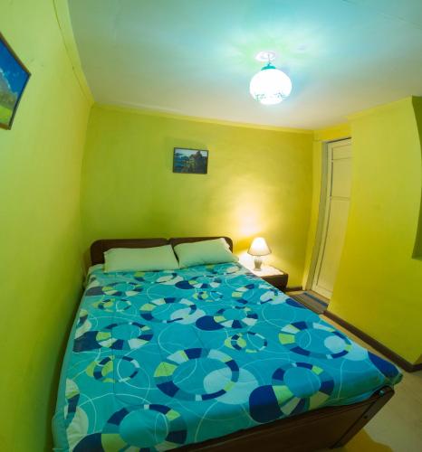 a bedroom with a bed with a blue at La Querencia in Cuenca