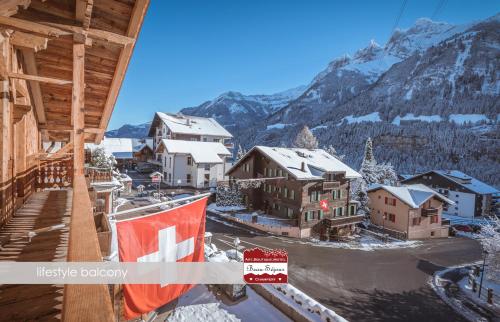 a view of a town in the mountains with snow at Lifestyle Rooms & Suites by Beau-Séjour in Champéry