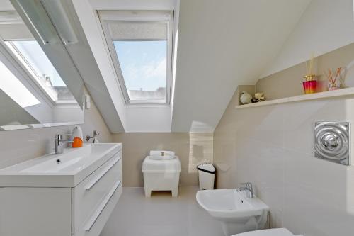 a bathroom with a sink and a toilet and a window at "Over the Rainbow" - Lovely house close to the Beach in Gdańsk