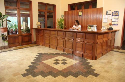a woman sitting at a counter in a room at Hotel Gloria Coroico in Coroico
