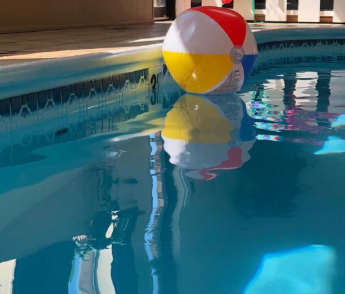 a beach ball is sitting in a swimming pool at Days Inn by Wyndham Oglesby/ Starved Rock in Oglesby