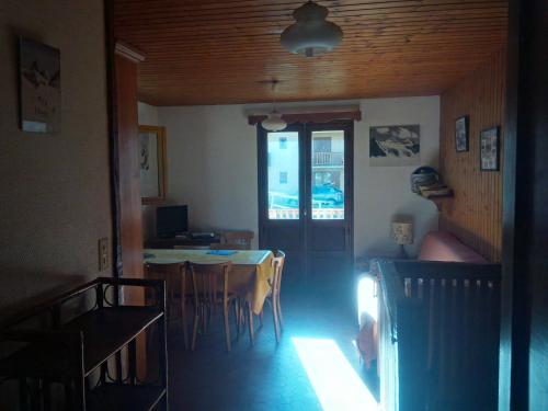 ein Esszimmer mit einem Tisch, einem Tisch und Stühlen in der Unterkunft appartement en duplex dans un chalet typique in Valloire