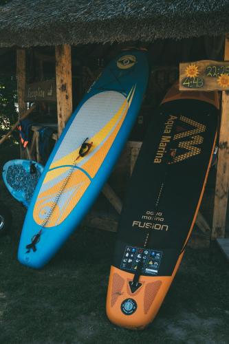 two surfboards are standing next to each other at Viesu nams Melnsils in Melnsils