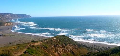 a view of a beach and the ocean with a mountain at Tiny Apartment Las Puyas Ocean View in Boca Pupuya