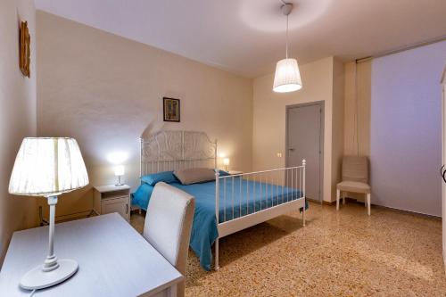 a bedroom with a bed and a table with a lamp at Istituto SS Salvatore in Orvieto