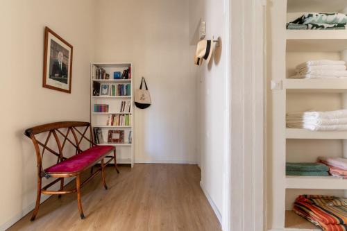 a room with a chair and a book shelf at The Pearl in Talbyeh in Jerusalem