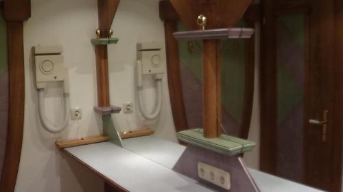 a bathroom with two urinals on the wall and a counter at Alpenhof in Lermoos