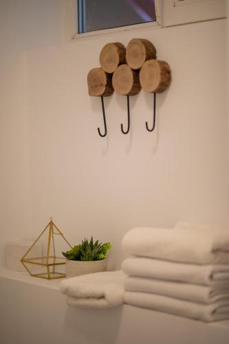 a group of towels and logs on a wall at Venice Boutique Aparthotel in Braşov