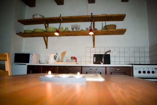 a kitchen with a wooden table with candles on it at Apartmány v Chalupe in Stará Lesná