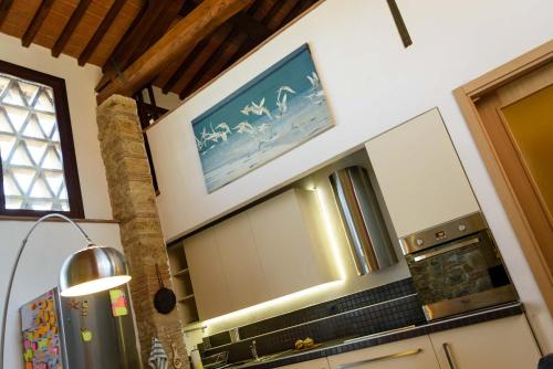 a kitchen with a large mirror above a stove at CasaJona Holiday in Poggibonsi