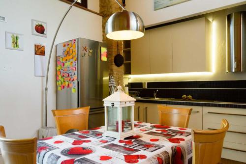 a kitchen with a table with a table cloth on it at CasaJona Holiday in Poggibonsi