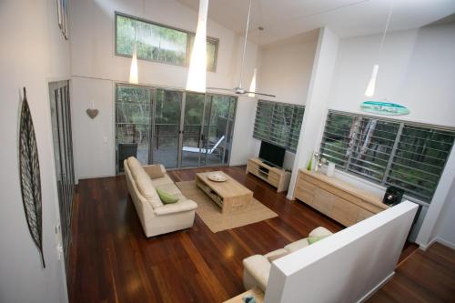 a living room with a couch and a table at The Sanctuary in Noosa North Shore