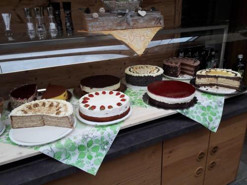 a table with different types of cakes on at Appartements Schwarzer Adler in Elbigenalp