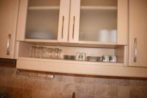 a kitchen with white cabinets and a sink at Villanaz Apart Hotel in Bitez