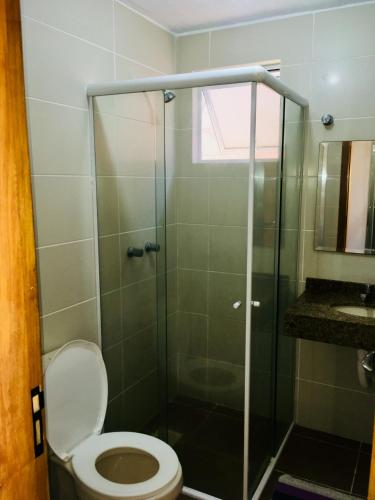a bathroom with a toilet and a glass shower at POUSADA TAQUARAS in Cassino