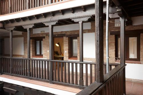 a porch of a building with a wooden railing at Apartamento Santiago in Granada