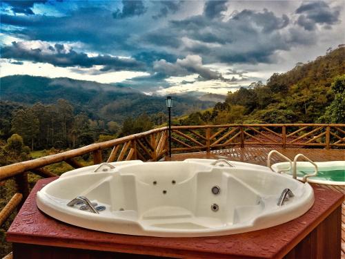 a bath tub sitting on a table with a view at Pousada Magia da Montanha in Visconde De Maua