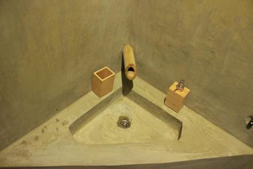 a sink in a bathroom with a pipe on the wall at Vanpila in Savannakhet