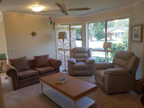 a living room with two couches and a coffee table at Robyn's Nest - Bed and Breakfast in Tewantin