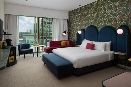 a hotel room with a bed and a large window at Ovolo The Valley Brisbane in Brisbane