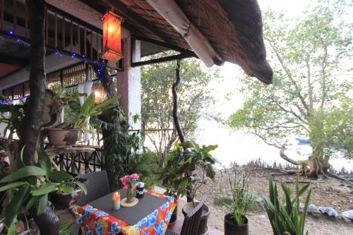 a patio with a table and plants on a building at Discovery Island Resort in Coron