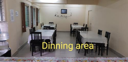 a dining area with tables and chairs with the words dining area at The Salvation Army RED SHIELD GUEST HOUSE in Kolkata
