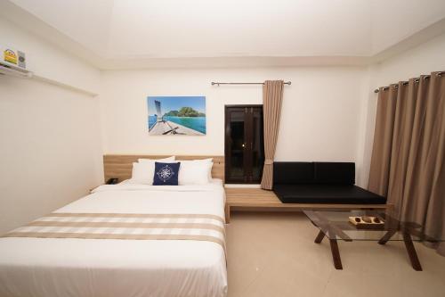 a hotel room with two beds and a table at Aquavana Haad Rin Resort in Haad Rin