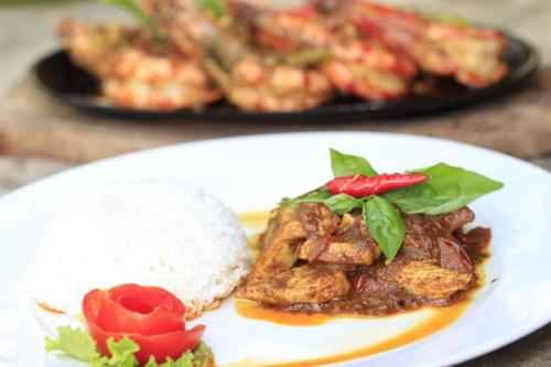 a white plate of food with rice and meat at Discovery Island Resort in Coron