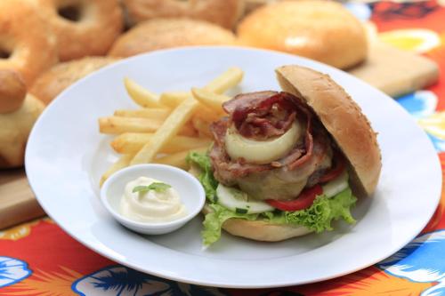 a plate of food with a sandwich and french fries at Discovery Island Resort in Coron