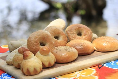 a tray of doughnuts and rolls on a table at Discovery Island Resort in Coron