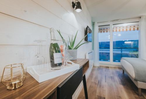 a kitchen with a sink and a bed and a window at Le Charme des 2 Lacs in Malbuisson