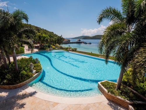 a swimming pool with a view of the water at Sunlight Ecotourism Island Resort in Culion