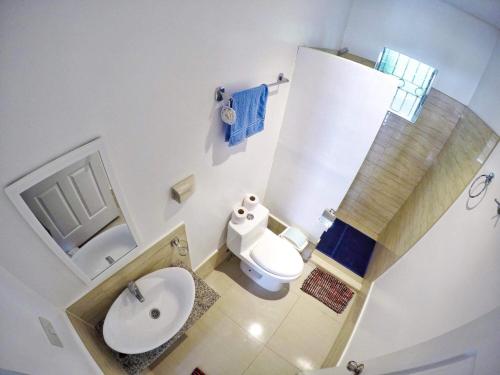a small bathroom with a sink and a toilet at Panglao Paradise Homes in Panglao