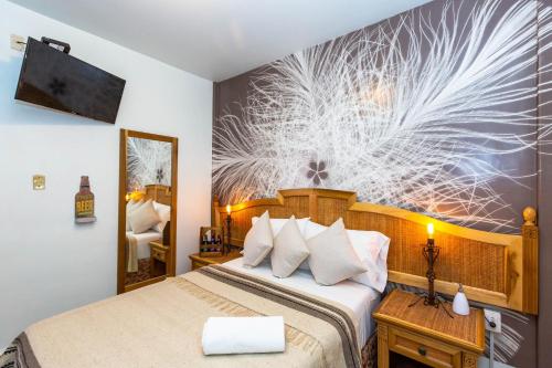 a hotel room with a bed and a wall mural at Mala Vecindad Beer Hotel in Mexico City