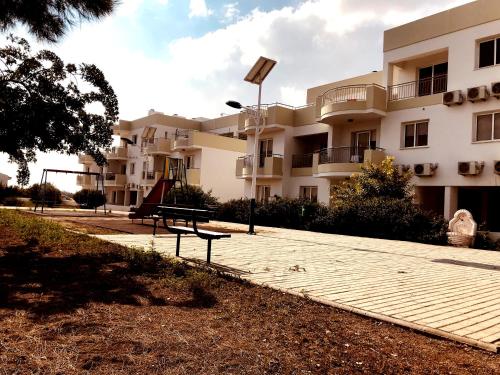 a building with a playground in front of it at Oceania Bay Village in Pyla