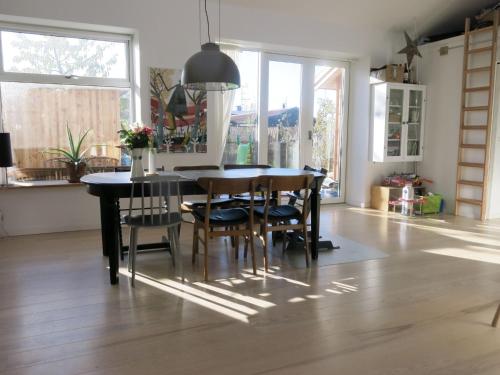 a kitchen with a dining room table and chairs at ApartmentInCopenhagen Apartment 1323 in Copenhagen